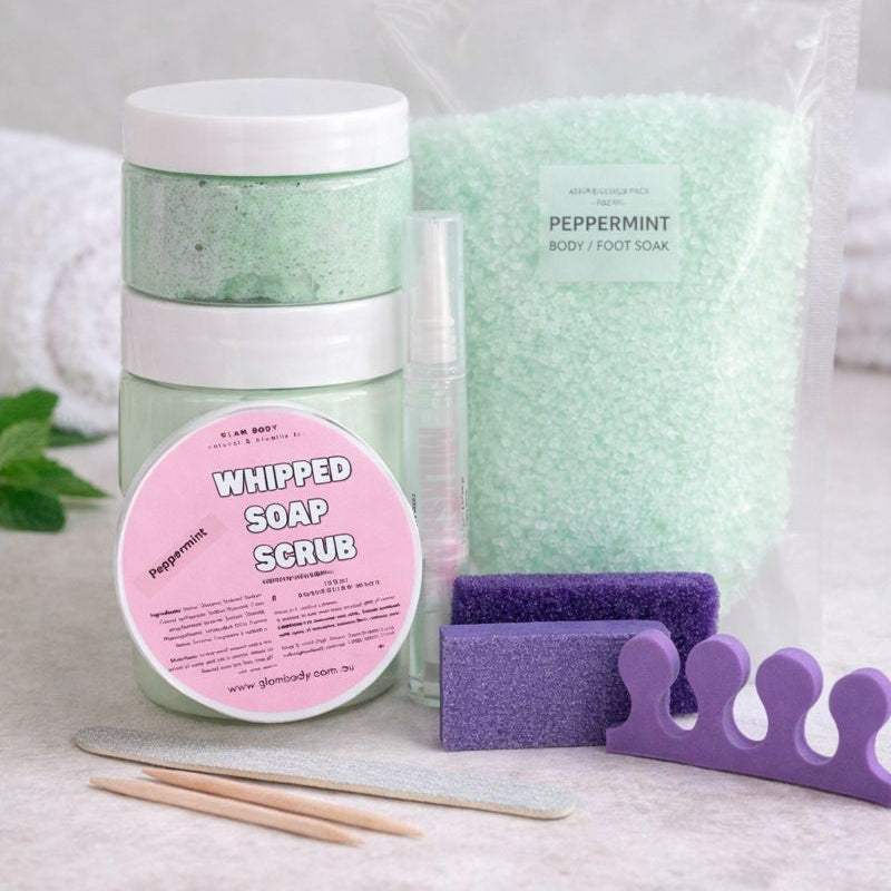 Whipped soap scrub with packaging and accessories on a light background