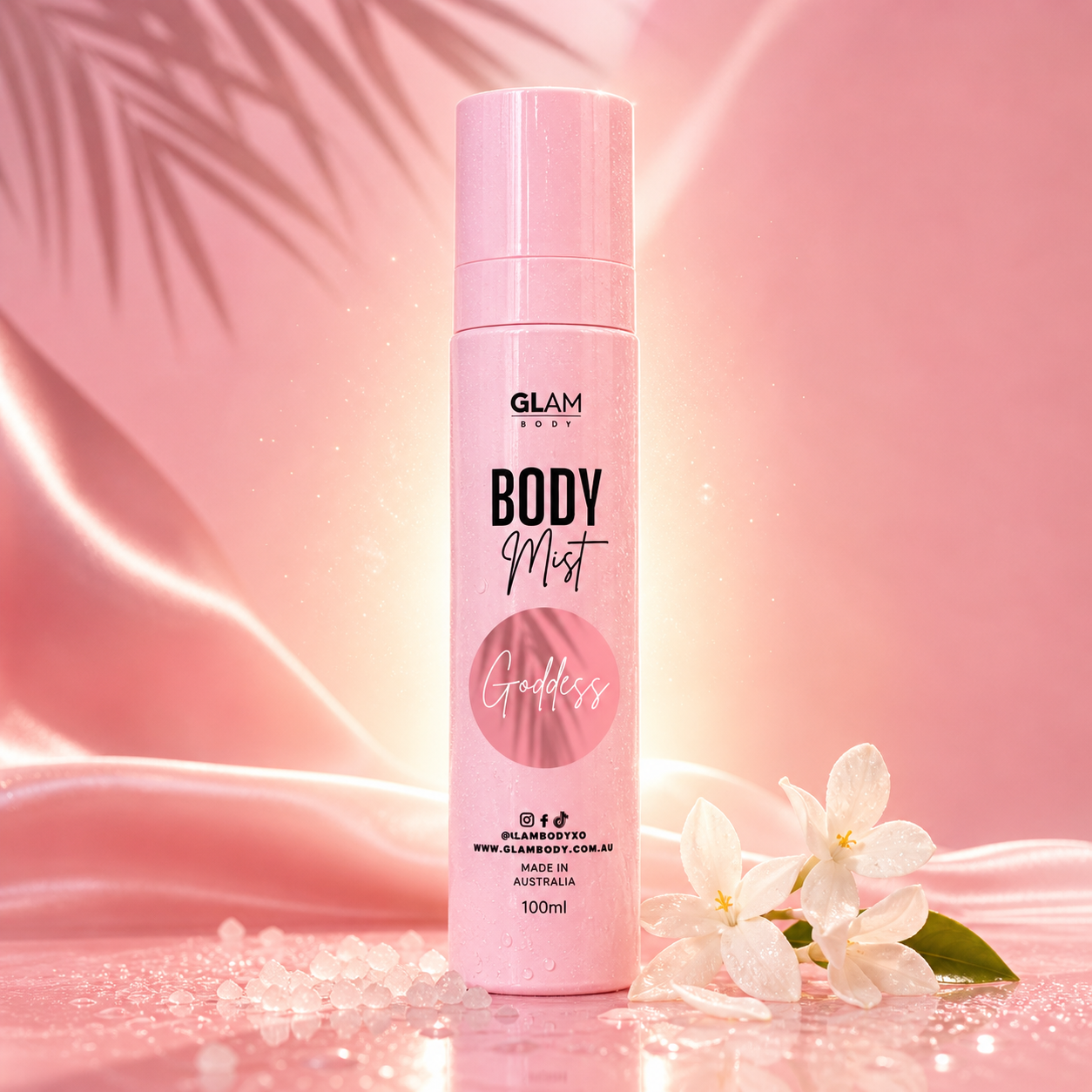 Pink 'GLAM BODY' body mist bottle with floral elements on a pink background