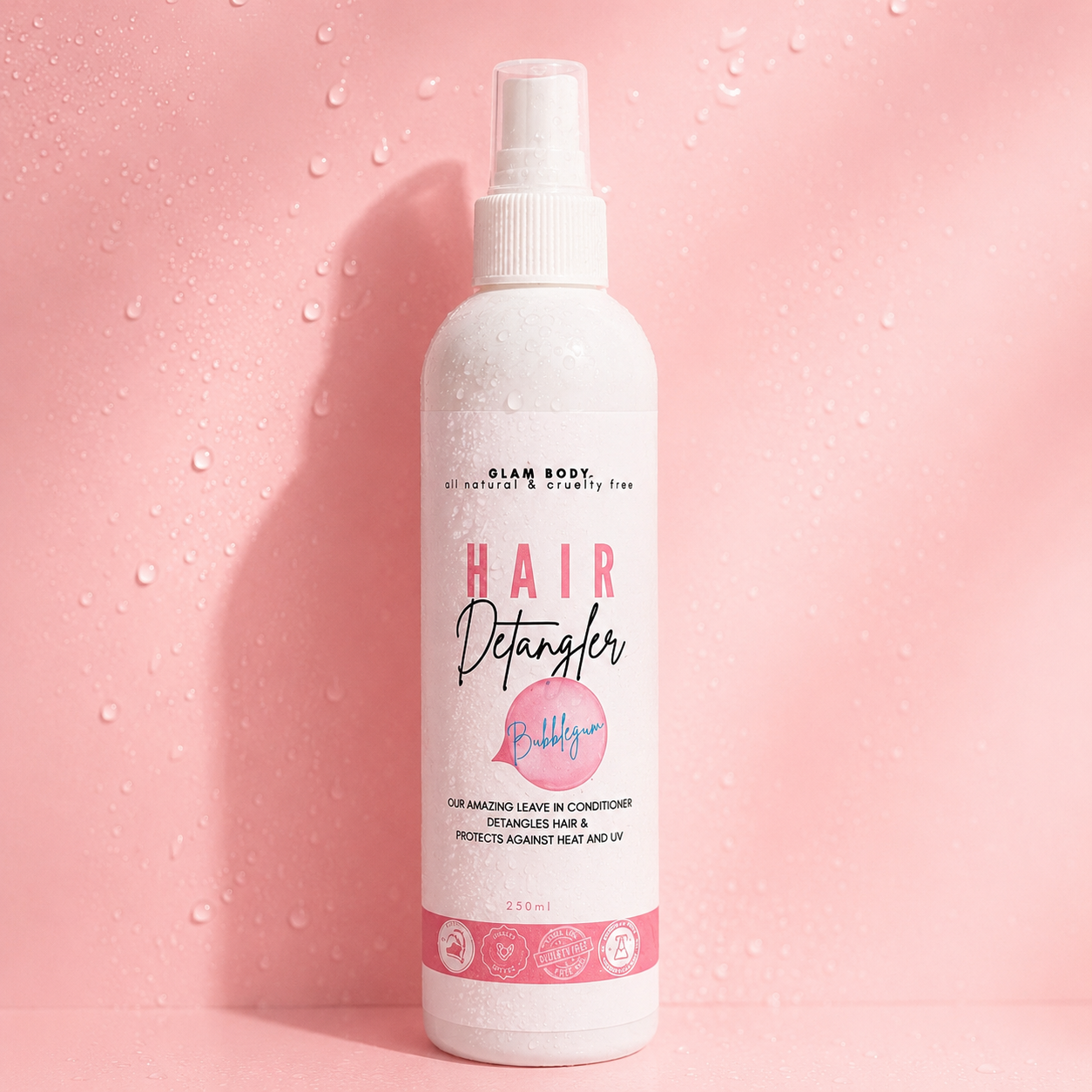 Hair detangler spray bottle on a pink background