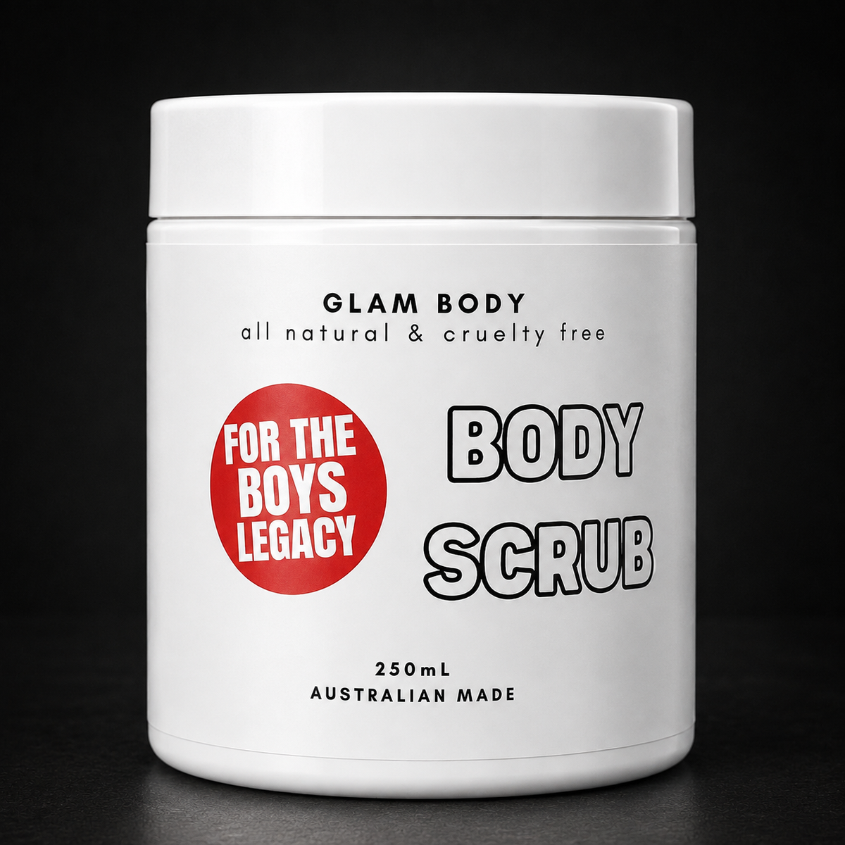 A white plastic jar of Glam Body Body Scrub with a white lid, featuring a red circular badge that reads 'FOR THE BOYS LEGACY' and black text on a black background.