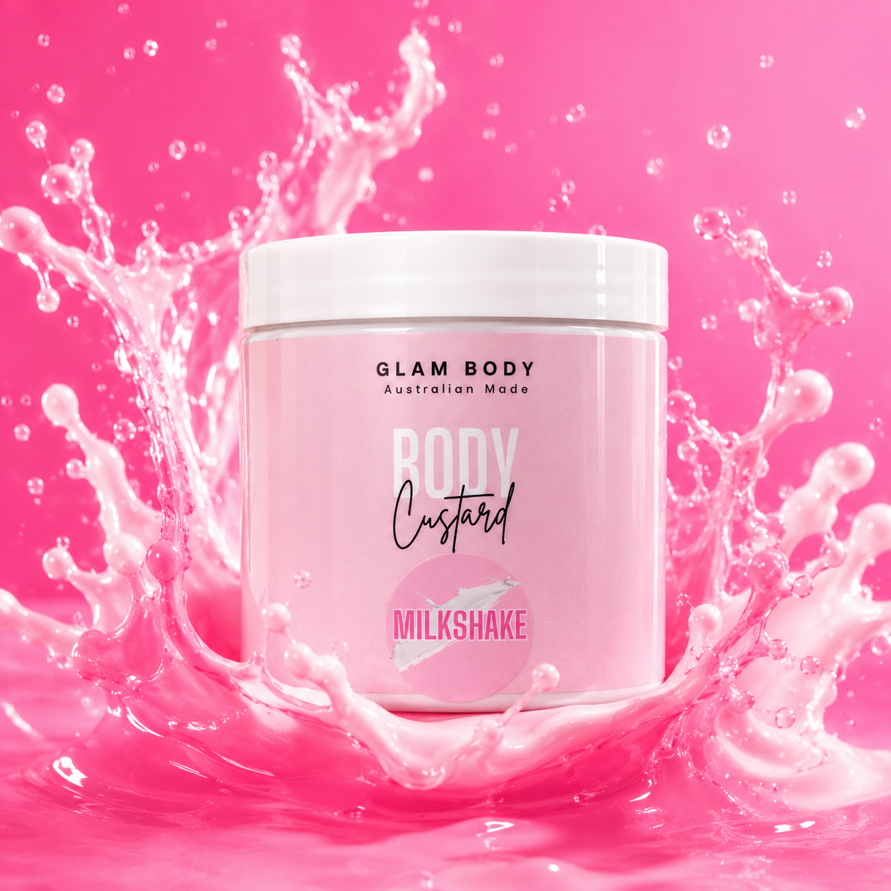 A pink tub of Glam Body Body Custard in the Milkshake flavor, surrounded by a dynamic splash of pink liquid on a vibrant pink background.