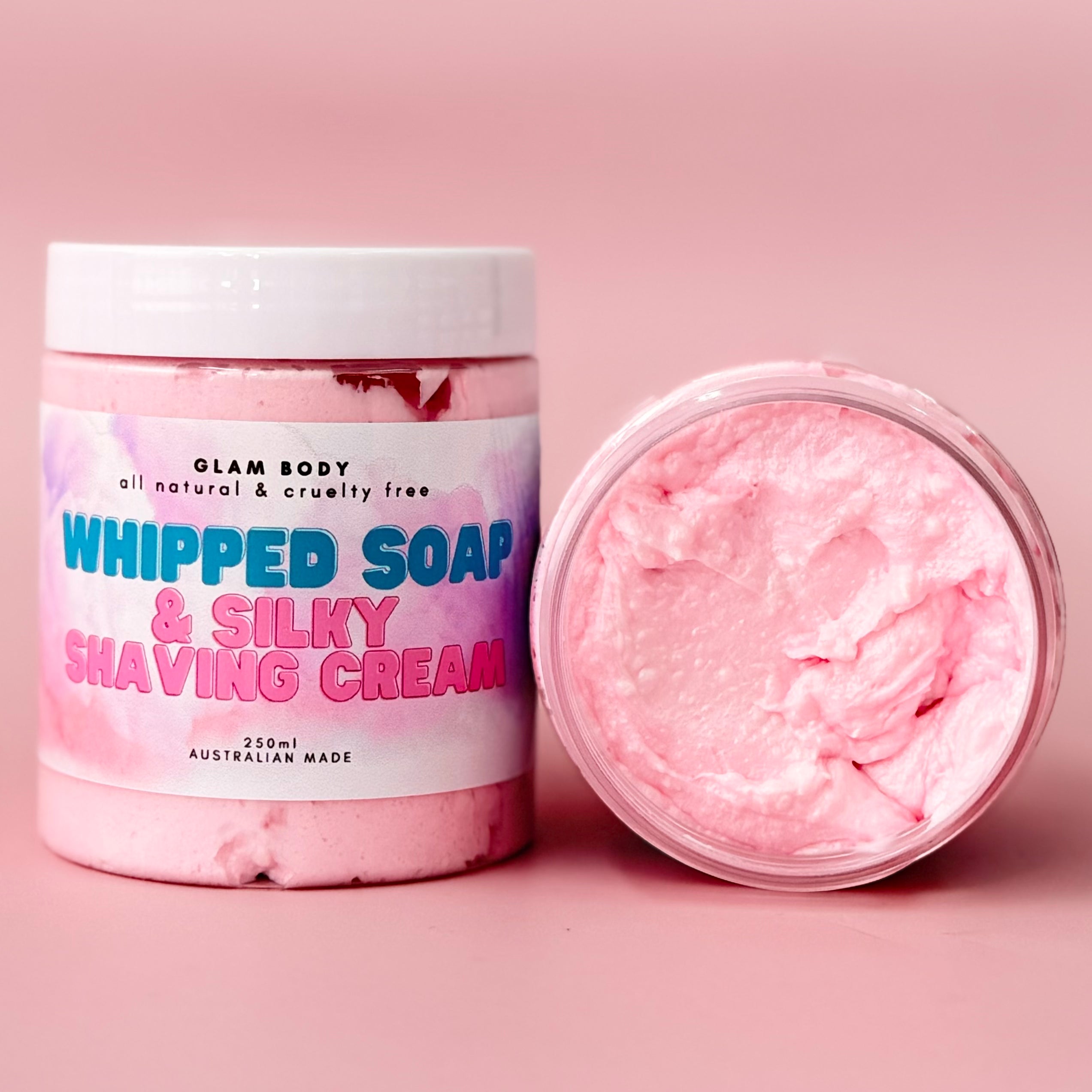 Pink whipped soap and silky shaving cream with a visible label on a pink background