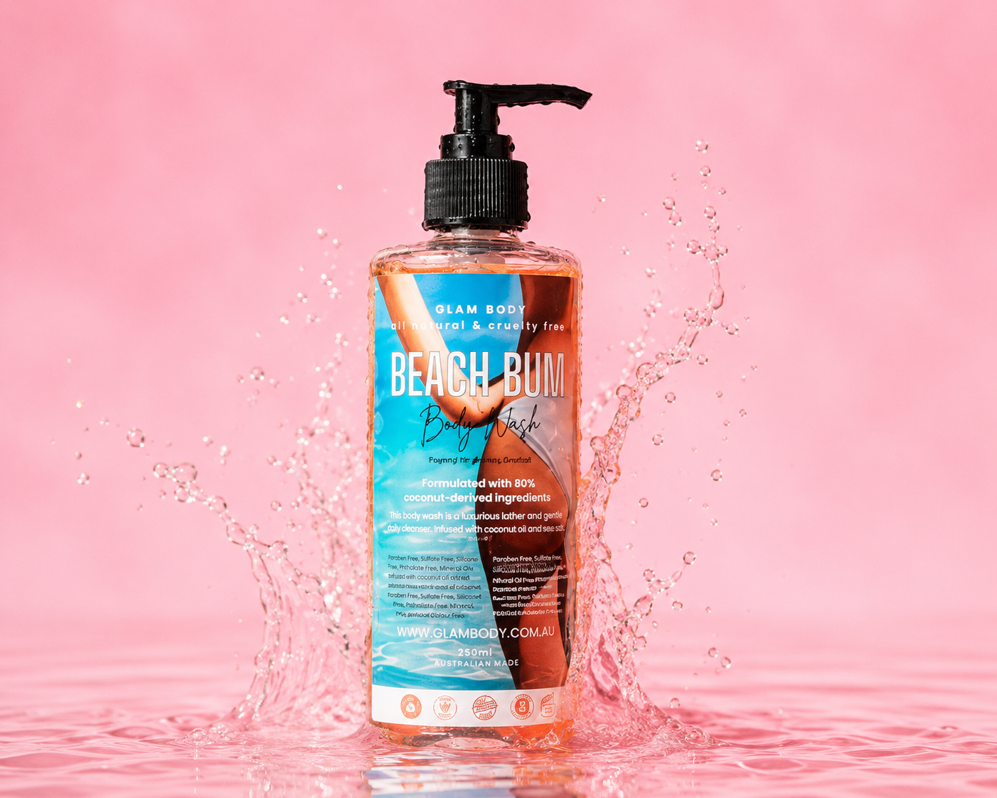 Bottle of Beach Bum body wash on a pink background with water splashes