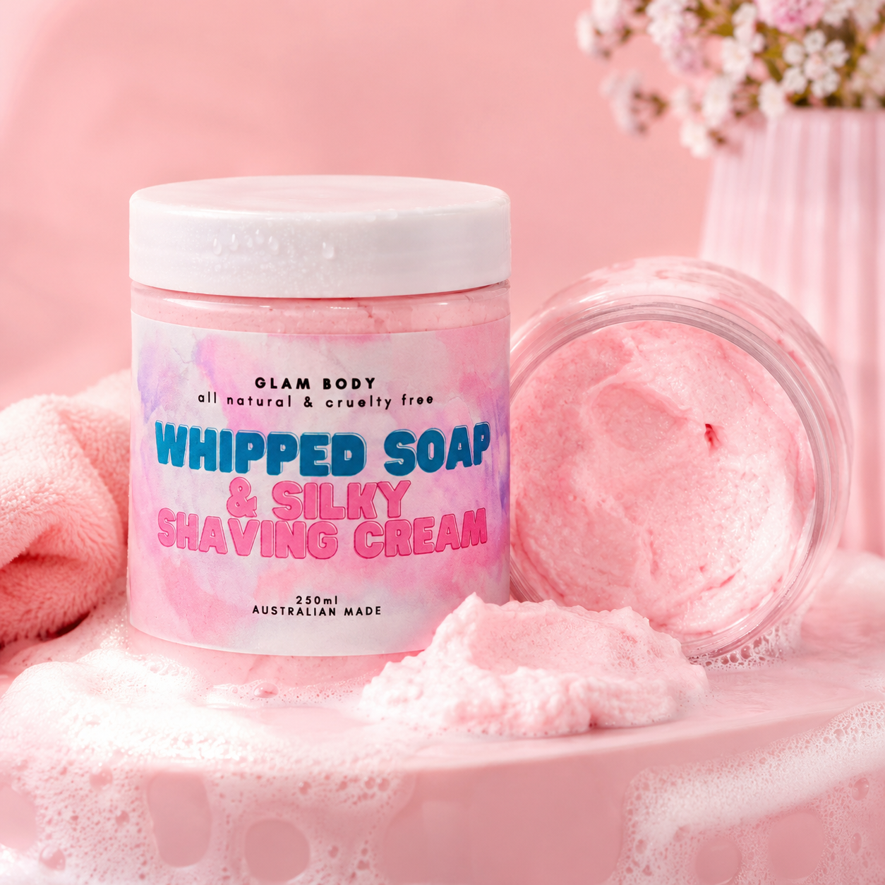 Jar of Glam Body whipped soap and silky shaving cream on a pink background