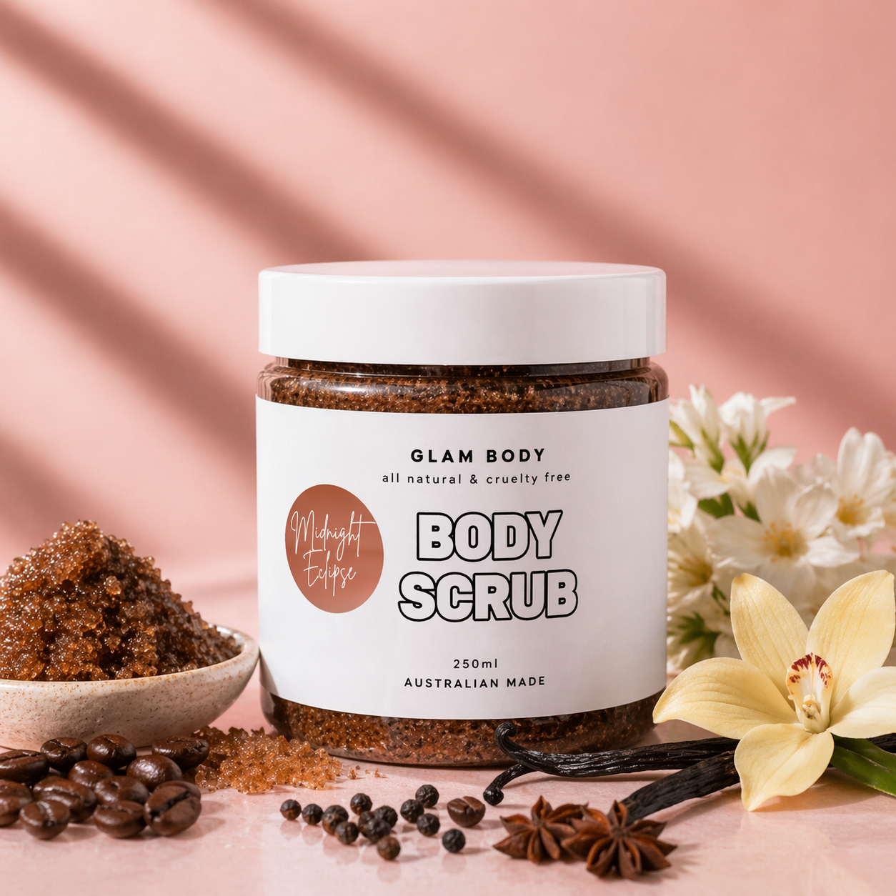 Jar of Glam Body body scrub with ingredients and flowers on a pink background