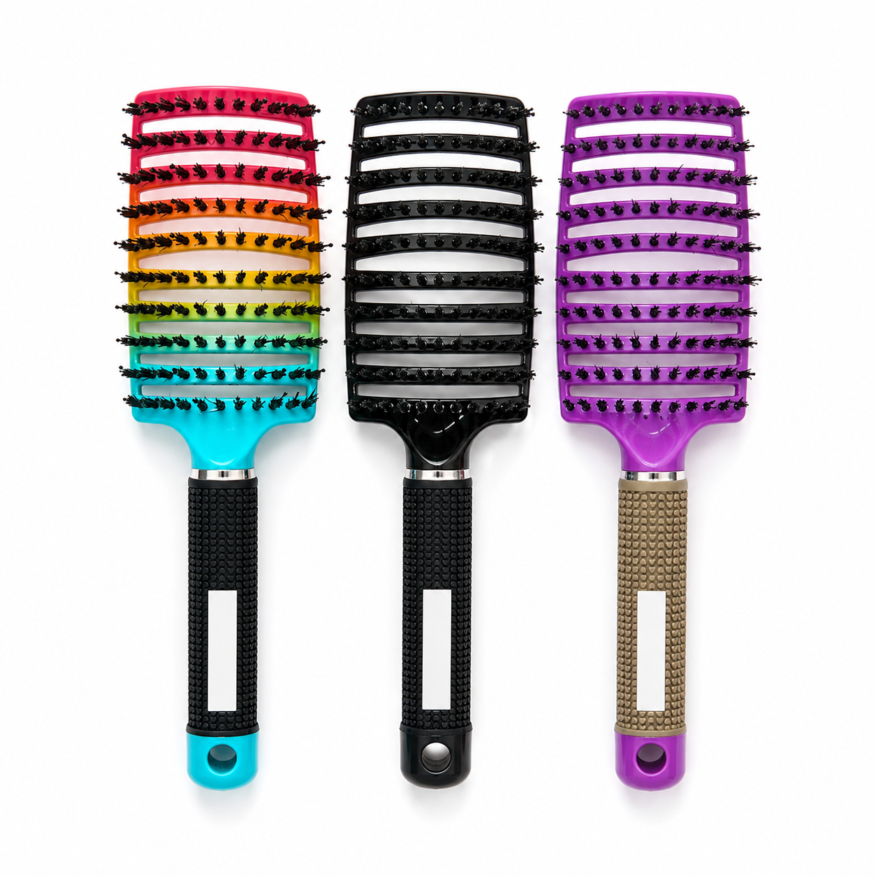 Three paddle hairbrushes arranged side by side on a white background. The left brush has a rainbow gradient bristle head with a turquoise handle.