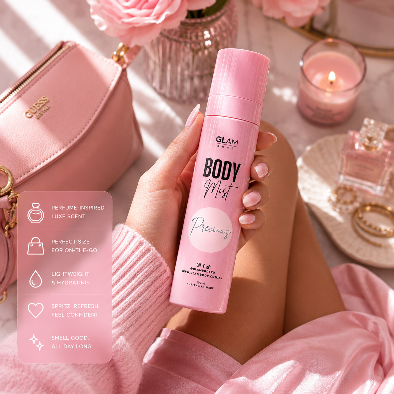 Person holding a pink 'GLAM' body mist with a pink handbag and decorative items in the background.