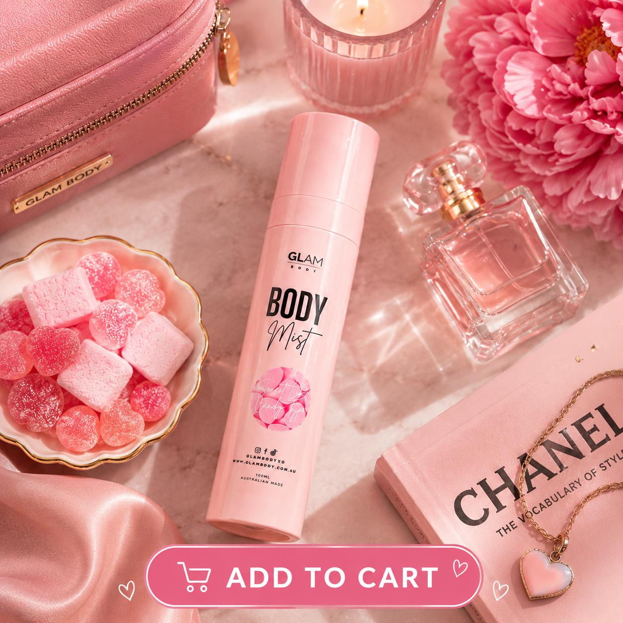 Pink body mist bottle, candy, and perfume on a pink surface with 'Glam Body' branding.