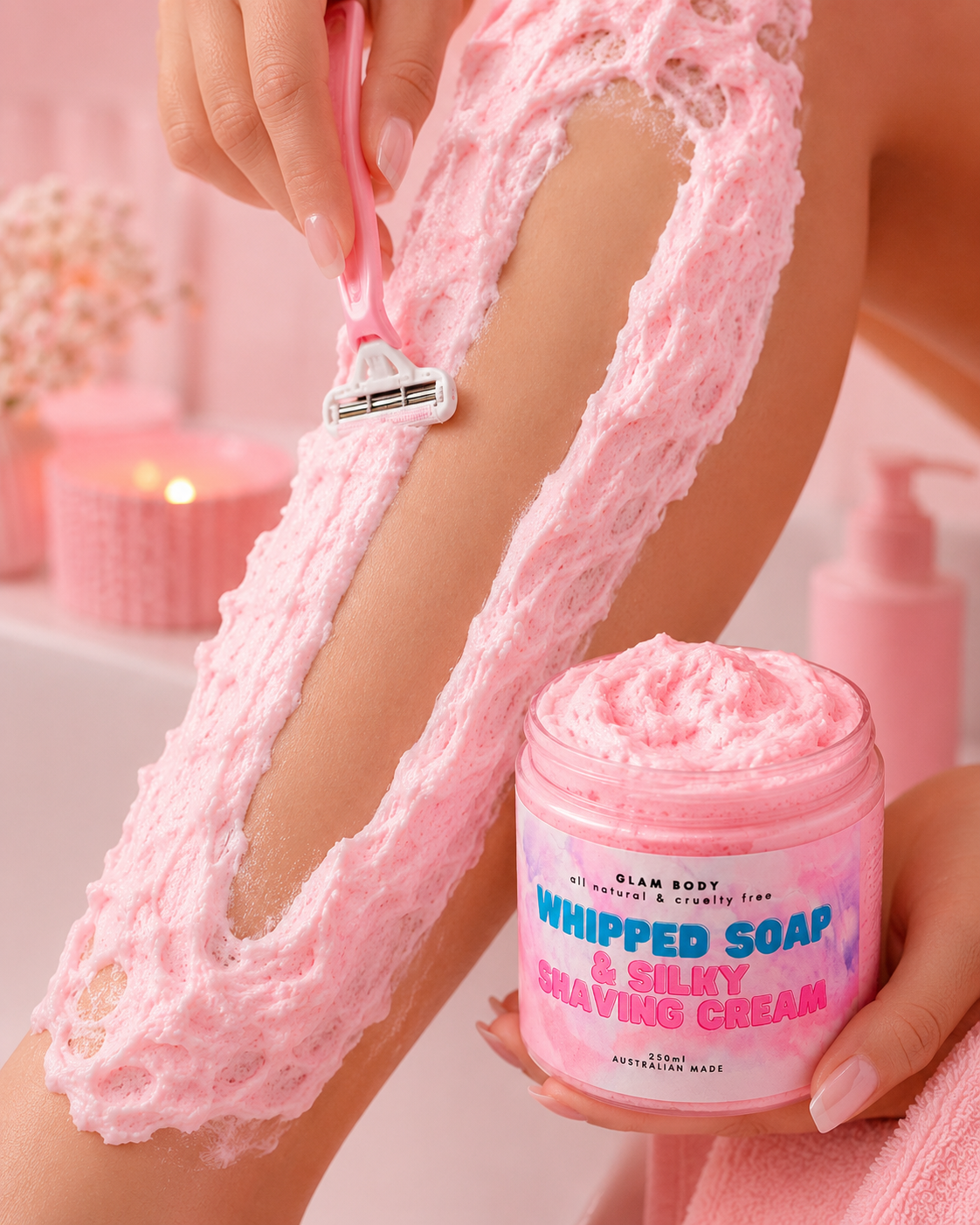 Person shaving leg with pink whipped soap and shaving cream, holding a jar of the product.