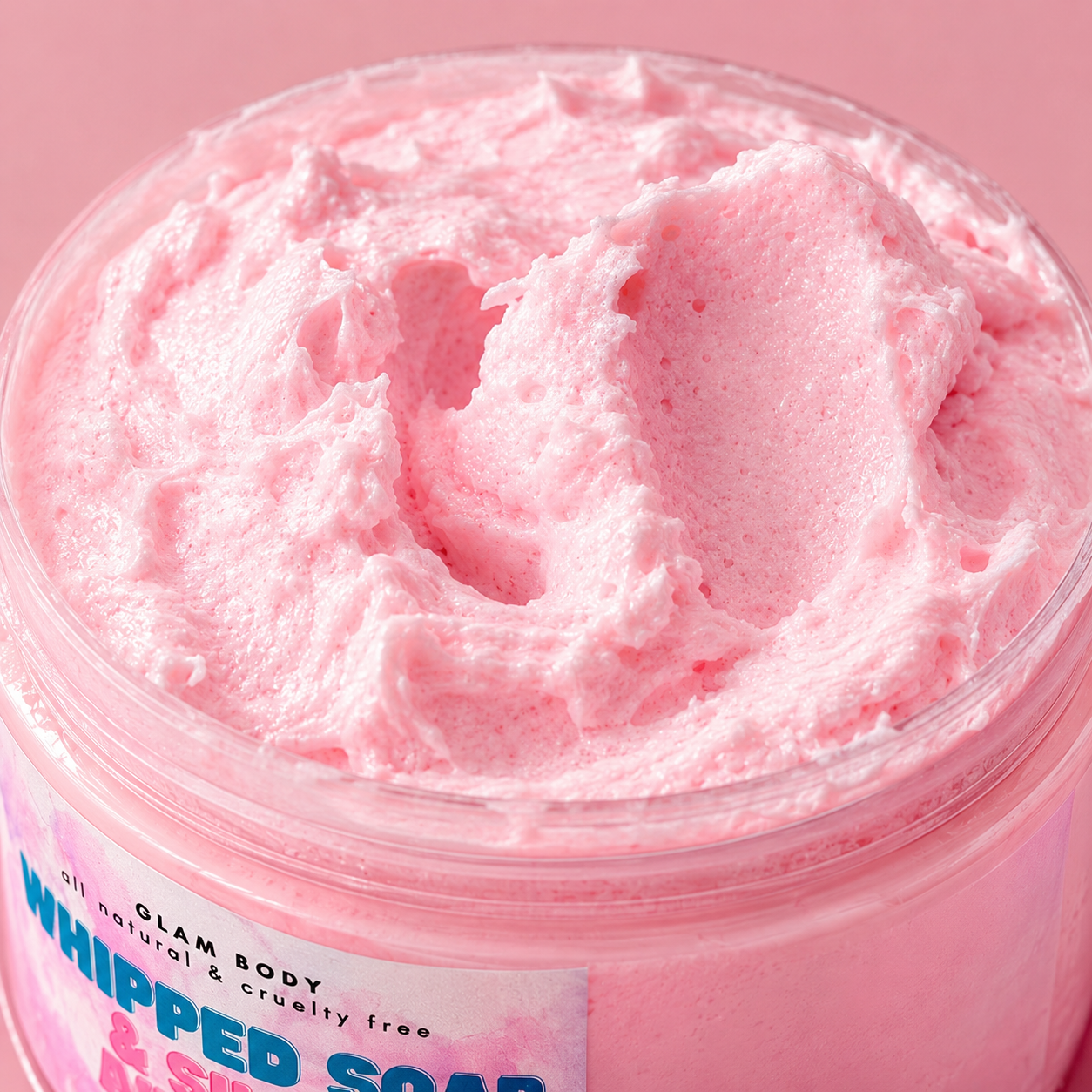 Pink whipped soap in a jar with 'Glam Body' label on a pink background